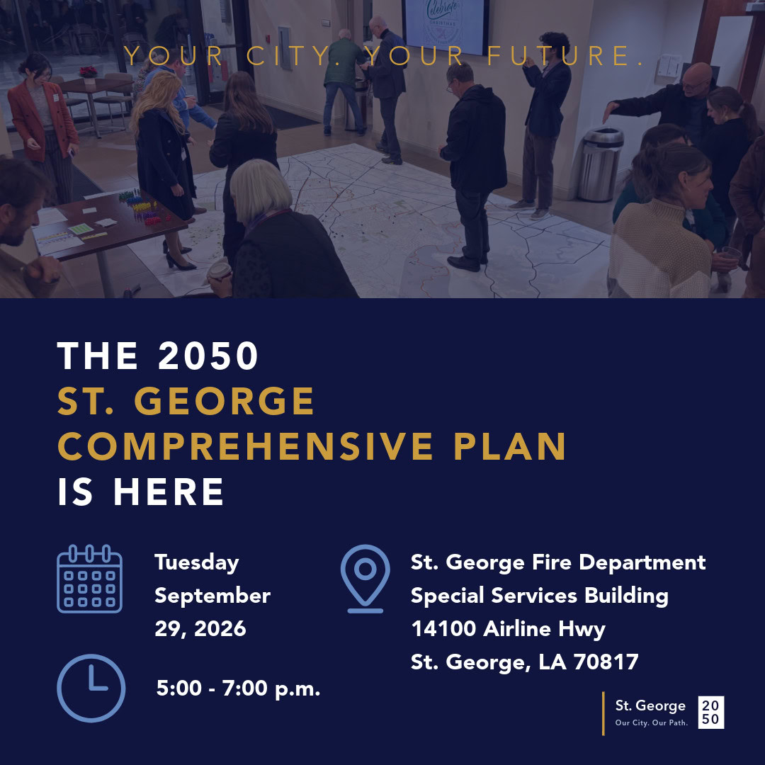 People discuss zoning and planning around tables with a large map at a St. George event.
